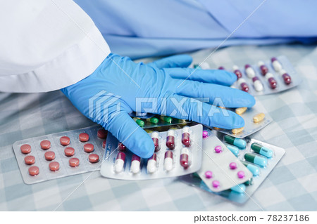 Asian doctor holding antibiotics capsule pills in blister packaging for treatment infection patient in hospital, Pharmacy drugstore concept. Asian doctor holding antibiotics capsule pills in blister packaging for treatment infection patient in hospital, Pharmacy drugstore concept. 78237186