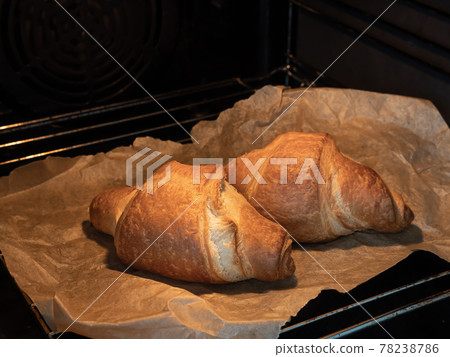 Baking handmade croissants in oven. Cooking food Baking handmade croissants in oven. Cooking food 78238786