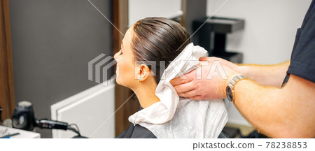 Hairdresser wipes hair of client 78238853