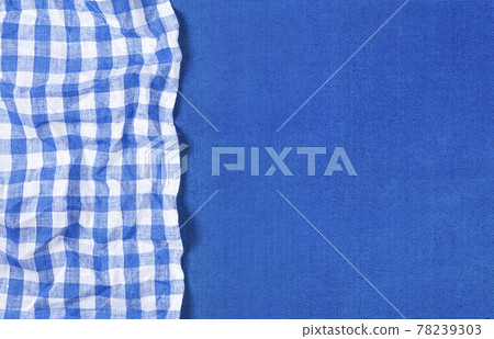 Blue canvas texture with blue checkered napkin, top view 78239303