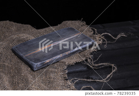 Dark wooden table for product, old black wooden perspective interior with old cutting board Dark wooden table for product, old black wooden perspective interior with old cutting board 78239335