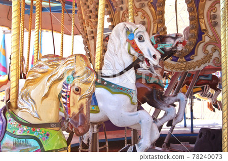 Vintage Carousel horses at rural carnival or fair 78240073