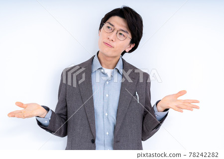 A man in a suit with glasses doing a hand-up pose A man in a suit with glasses doing a hand-up pose 78242282