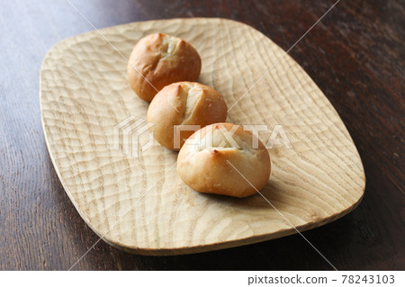 Bread lined up on a wooden plate Bread lined up on a wooden plate 78243103