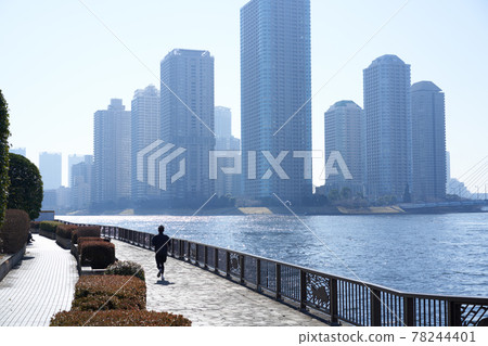 在隅田川沿岸的摩天大樓的背景下慢跑的男人 在隅田川沿岸的摩天大樓的背景下慢跑的男人 78244401