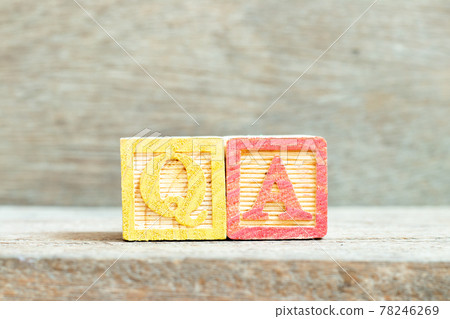 Color alphabet letter block in word QA (abbreviation of quality assurance or question and answer) on wood background 78246269