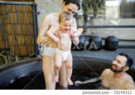 Family at spa with a young baby 78249312