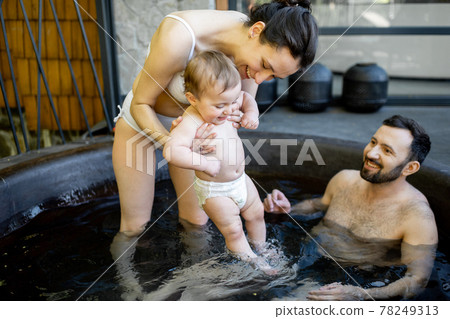 Family at spa with a young baby 78249313