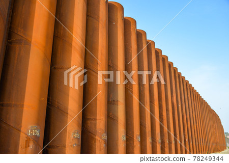 High iron wall on the beach High iron wall on the beach 78249344