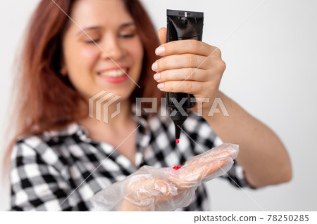 Young woman dyes her hair at home. Bright hair coloring concept. 78250285