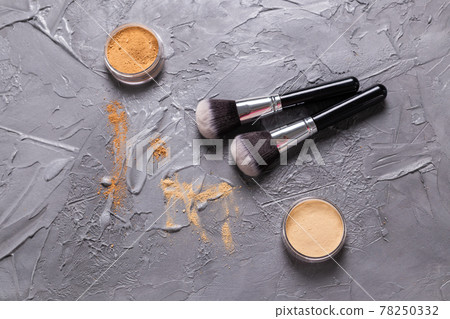 Mineral powder of different colors with a brushes for make-up on wooden background, top view Mineral powder of different colors with a brushes for make-up on wooden background, top view 78250332