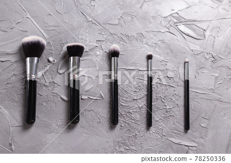 Top view of make-up brushes on grey background Top view of make-up brushes on grey background 78250336
