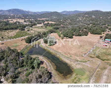 Aerial view of small lake in the valley, between farmland and forest in the town of Julian, east of San Diego, Aerial view of small lake in the valley, between farmland and forest in the town of Julian, east of San Diego, 78251593