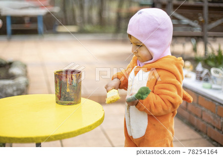 adorable little toddler paints yellow round table with brush adorable little toddler paints yellow round table with brush 78254164