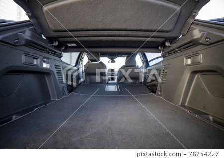 empty trunk of a modern car with folded rear seats. large interior volume. trunk view 78254227