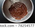 Melting chocolate in pot on dark 78254577