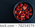 Fresh berries on dark plate on table 78254579