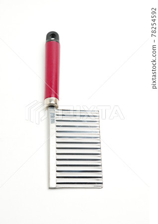 Wavy knife for slicing french fries, vegetable chips and fruits on a white background Wavy knife for slicing french fries, vegetable chips and fruits on a white background 78254592