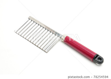 Wavy knife for slicing french fries, vegetable chips and fruits on a white background Wavy knife for slicing french fries, vegetable chips and fruits on a white background 78254594