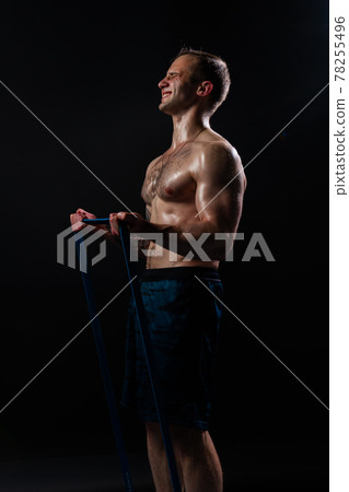 Man on black background keeps dumbbells pumped up in fitness biceps torso, arm fitness lifting heavy, healthy Attractive metal, human fit With a ribbon in hand, the fitness gum is black Man on black background keeps dumbbells pumped up in fitness biceps torso, arm fitness lifting heavy, healthy Attractive metal, human fit With a ribbon in hand, the fitness gum is black 78255496