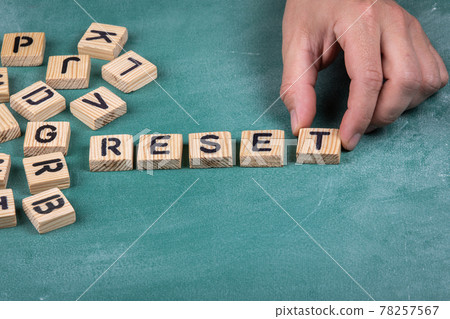 RESET. Wooden alphabet letters on a green blackboard background RESET. Wooden alphabet letters on a green blackboard background 78257567