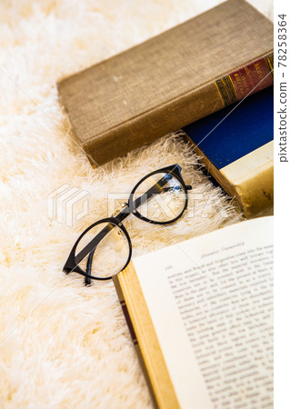 Material image of classic image of foreign books and glasses 78258364