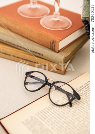 Material image of antique image of foreign books and glasses 78260135