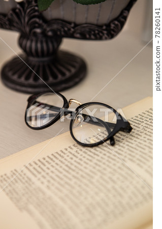 Material image of antique image of foreign books and glasses 78260141