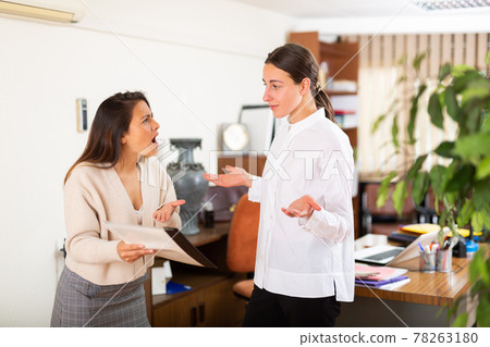 Irritated woman boss scolding manager for incompetence 78263180