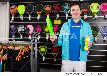 male holding new rocket and balls for padel male holding new rocket and balls for padel 78263229