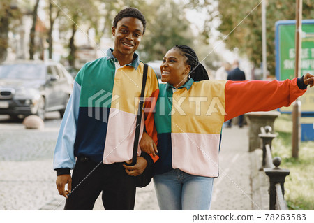 Ethnic couple walking in city street Ethnic couple walking in city street 78263583