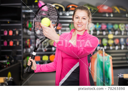 woman is testing new rocket and ball for tennis 78263898