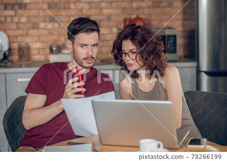 Two people working on project and looking busy 78266199