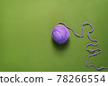 Purple Yarn Ball Thread on green Background. 78266554