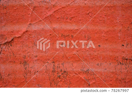 The painted wall of the facade is in bright red. Texture. The painted wall of the facade is in bright red. Texture. 78267997