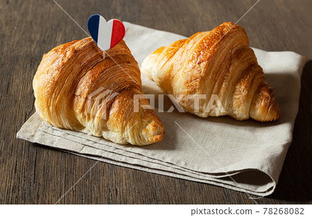 Two fresh croissants on a table 78268082