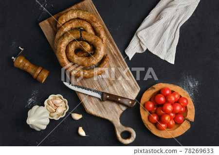Horse meat sausage rolled on wooden cutting board Horse meat sausage rolled on wooden cutting board 78269633