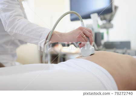 Ultrasound scanner device in hand of professional doctor examining his patient 78272740
