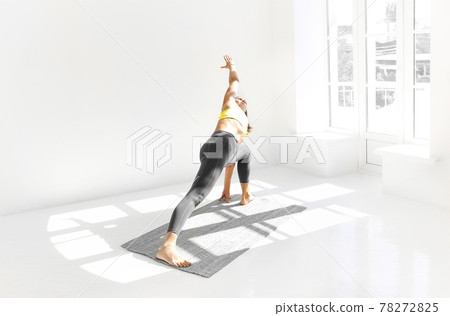 Flexible woman doing yoga at home 78272825