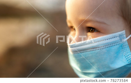 Happy little girl with protective mask looking away 78273584