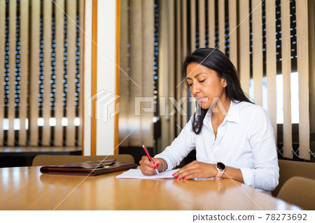 Young adult woman working in meeting room 78273692