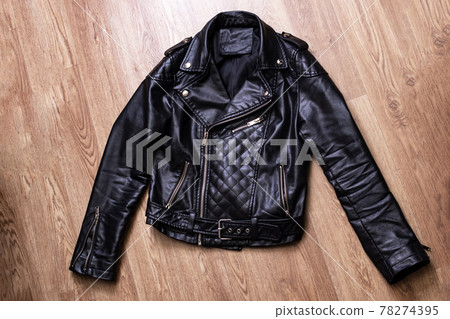 Black leather jacket on a wooden background 78274395