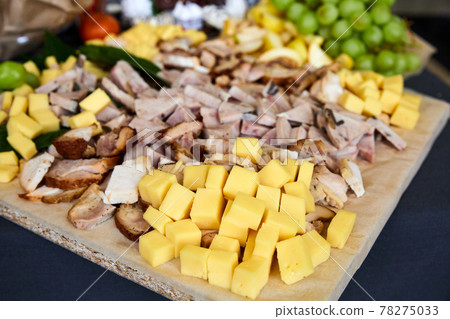 Plate with pieces of various cheeses and meat. Close-up, selective focus Plate with pieces of various cheeses and meat. Close-up, selective focus 78275033