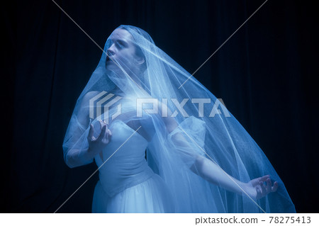 Young graceful balerina in image of ghost bride in art performance isolated on dark background in neon light. Young graceful balerina in image of ghost bride in art performance isolated on dark background in neon light. 78275413