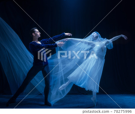 Young woman in wedding dress and man, two ballet dancers in art performance dancing isolated over dark background. Young woman in wedding dress and man, two ballet dancers in art performance dancing isolated over dark background. 78275996