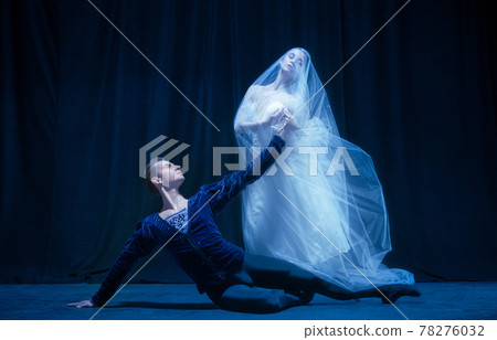 Beautiful graceful woman and man, ballet dancers in art performance dancing isolated over dark background Beautiful graceful woman and man, ballet dancers in art performance dancing isolated over dark background 78276032