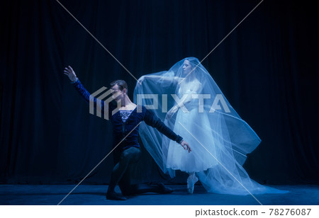 Art performance. Two graceful ballet dancers, man and woman dancing isolated over dark background. Art performance. Two graceful ballet dancers, man and woman dancing isolated over dark background. 78276087