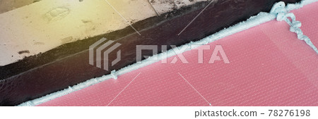 Construction foam between pink extruded styrofoam sheets Construction foam between pink extruded styrofoam sheets 78276198