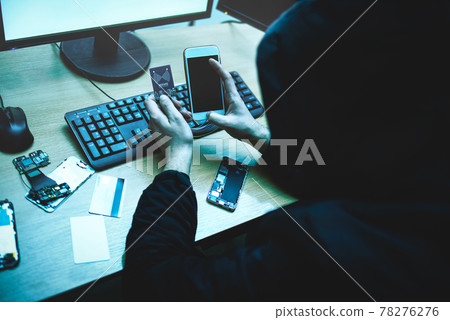 Male hacker is trying to access the phone. Security and protection of personal data. The concept of cyber crime and hacking 78276276