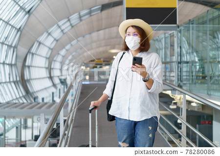 New Normal tourist wearing face mask is traveling on The airport , New lifestyle travel after covid-19. Social distancing healthcare system ,stay safe and Travel bubble concept. New Normal tourist wearing face mask is traveling on The airport , New lifestyle travel after covid-19. Social distancing healthcare system ,stay safe and Travel bubble concept. 78280086
